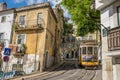Very touristic place in the old part of Lisbon, with a traditional tram passing by in the city of Lisbon, Portugal.